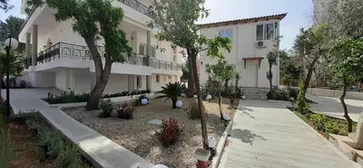 a house with a courtyard with trees and plants at Archontiko Voulas D in Athens