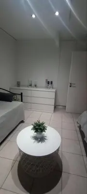 a white room with a table with a plant on it at Sweet Nest in Piraeus