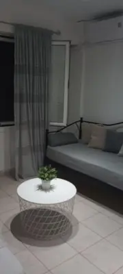 a living room with a couch and a coffee table at Sweet Nest in Piraeus