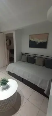 a bedroom with a large bed and a table at Sweet Nest in Piraeus