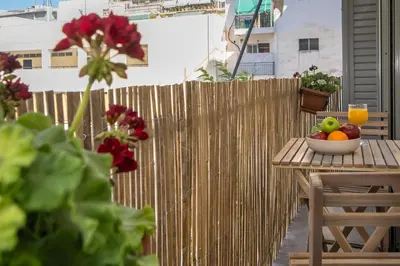 a bowl of fruit on a table on a balcony at Encrin Apartment by LobbySquare in Athens