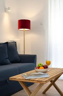 a coffee table with a bowl of fruit and a glass of juice at Encrin Apartment by LobbySquare in Athens