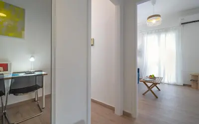 a white room with a desk and a table at Encrin Apartment by LobbySquare in Athens