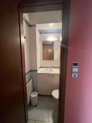 a small bathroom with a sink and a toilet at Cozy apartment Neo Psychiko in Athens