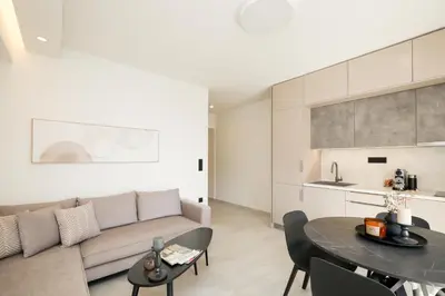 a living room with a couch and a table at Sunny Seaside Cozy Home in Piraeus
