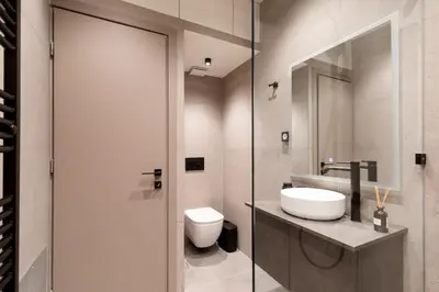 a bathroom with a sink and a toilet and a mirror at Sunny Seaside Cozy Home in Piraeus