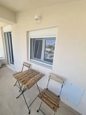 two benches sitting in a room with a window at IVory Suites near Athens Airport in Spáta