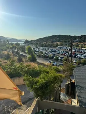 a parking lot with a lot of parked cars at Aggelakos Rooms in Porto Rafti