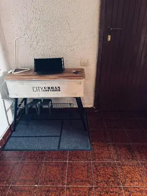 a white piano sitting in a room with a door at Aggelakos Rooms in Porto Rafti