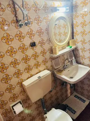 a bathroom with a sink and a toilet and a mirror at Aggelakos Rooms in Porto Rafti