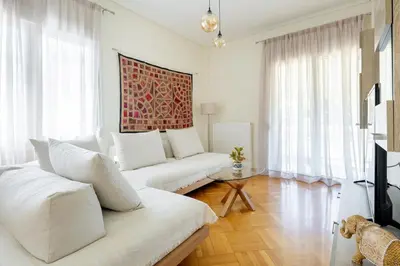 a white living room with a couch and a table at Beach & City - Glyfada 2BR in Athens