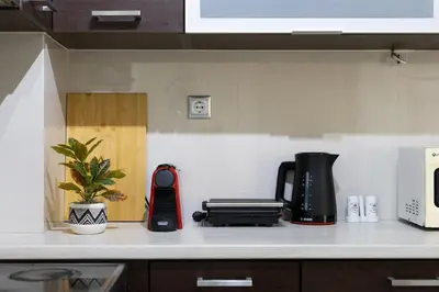a kitchen counter with a black and red appliance on it at Beach & City - Glyfada 2BR in Athens