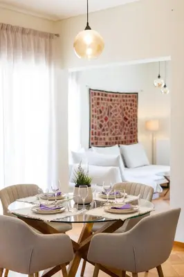 a dining room with a table and chairs at Beach & City - Glyfada 2BR in Athens