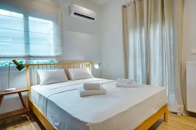 a bedroom with a bed with two towels on it at Garden Level Gem in the City in Athens