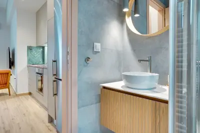 a bathroom with a sink and a mirror at Garden Level Gem in the City in Athens