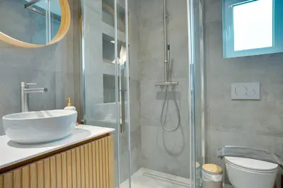 a bathroom with a shower with a sink and a toilet at Garden Level Gem in the City in Athens