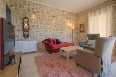 a living room with a couch and a chair at Modern Greek Escape close to Alimos Shore in Athens