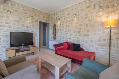 a living room with a red couch and a tv at Modern Greek Escape close to Alimos Shore in Athens