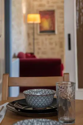 a table with a bowl and a glass on it at Modern Greek Escape close to Alimos Shore in Athens