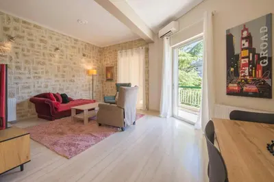 a living room with a red couch and a window at Modern Greek Escape close to Alimos Shore in Athens