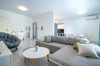 a living room with a couch and a table at Barbara's sweet home Glyfada by ΜΡS in Athens