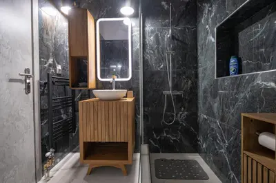 a bathroom with a sink and a mirror at Barbara's sweet home Glyfada by ΜΡS in Athens