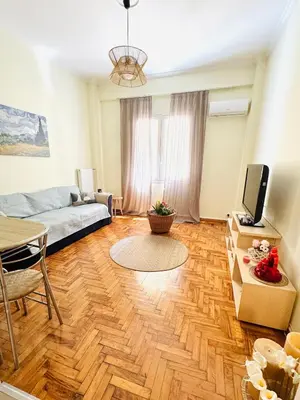 a living room with a couch and a tv at Gaia Casa Athens in Athens