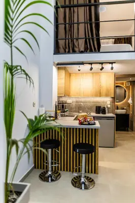 a kitchen with a counter with two stools at Studio Terra in Athens