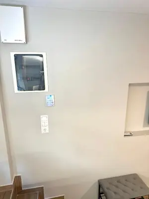 a white wall with a window in a stair case at TAVROS suites in Athens