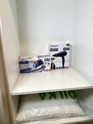 a white shelf in a refrigerator with boxes on it at TAVROS suites in Athens