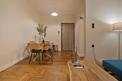 a living room with a table and a dining room at Historic Boutique Apartment in Artists' Kipseli in Athens