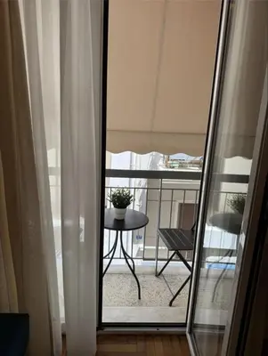 a view of a balcony with a table and a chair at Historic Boutique Apartment in Artists' Kipseli in Athens