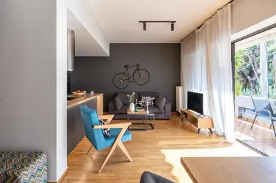 a living room with a couch and a table at Spacious 3-Bedroom Getaway with Balcony in Glyfada in Athens