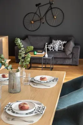a living room with a table with plates on it at Spacious 3-Bedroom Getaway with Balcony in Glyfada in Athens