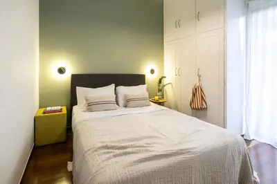 a bedroom with a large bed with white sheets at Spacious 3-Bedroom Getaway with Balcony in Glyfada in Athens