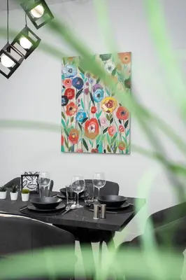 a table with glasses and a painting on the wall at Bright 2 bedroom apartment in Palaio Faliro in Athens