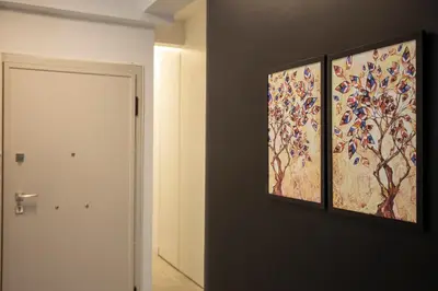 a hallway with two paintings on the wall next to a door at Bright 2 bedroom apartment in Palaio Faliro in Athens