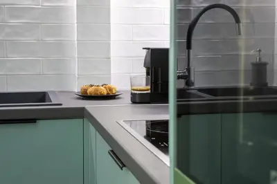 a kitchen with a sink and a plate of food at Bright 2 bedroom apartment in Palaio Faliro in Athens