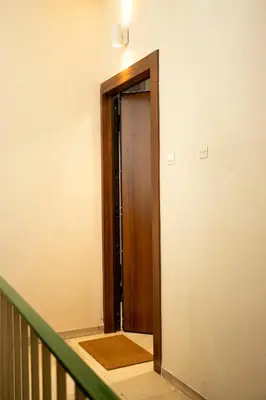 an empty hallway with a wooden door in a building at Bright 2 bedroom apartment in Palaio Faliro in Athens