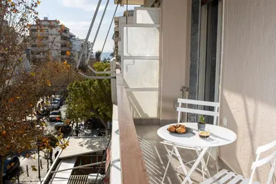 a plate of food on a table on a balcony at Bright 2 bedroom apartment in Palaio Faliro in Athens