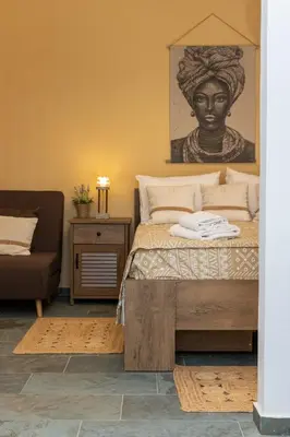 a bedroom with a bed with a bust of a woman at Hillside Suite Athens in Athens