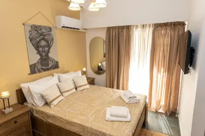 a bedroom with a bed with two towels on it at Hillside Suite Athens in Athens