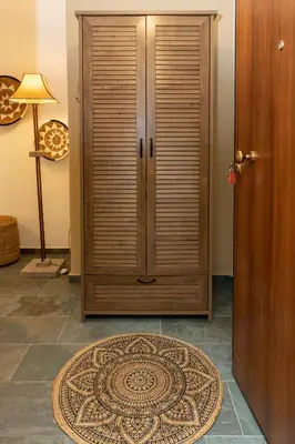 a wooden cabinet in a room with a rug at Hillside Suite Athens in Athens