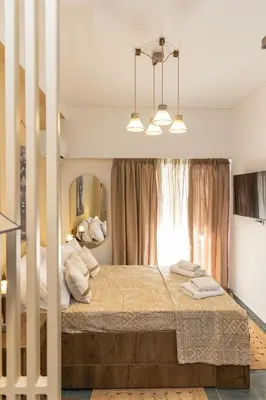 a bedroom with a bed with two towels on it at Hillside Suite Athens in Athens