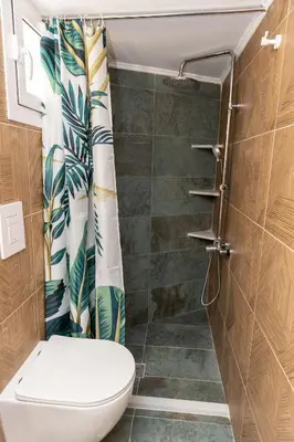 a bathroom with a toilet and a shower at Hillside Suite Athens in Athens