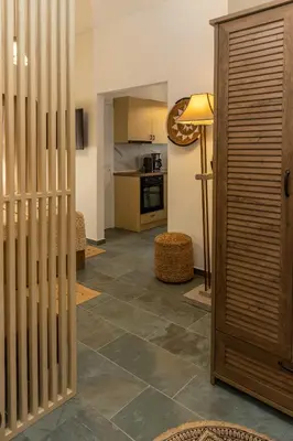a living room with a tile floor and a kitchen at Hillside Suite Athens in Athens