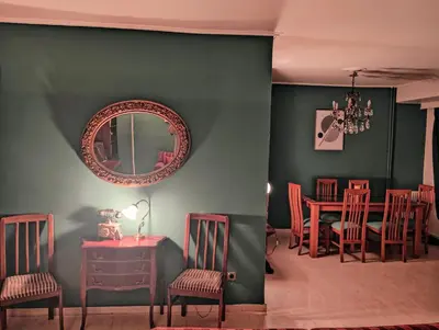 a dining room with a table and chairs and a mirror at Minimal Vintage διαμέρισμα στο κέντρο της Αθήνας in Athens