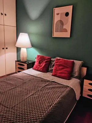 a bedroom with a bed with red pillows at Minimal Vintage διαμέρισμα στο κέντρο της Αθήνας in Athens