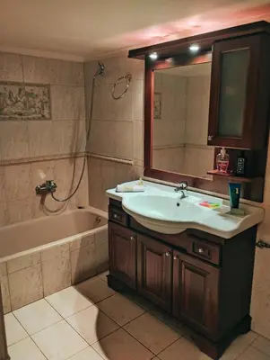 a bathroom with a sink and a mirror and a tub at Minimal Vintage διαμέρισμα στο κέντρο της Αθήνας in Athens