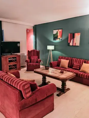 a living room with two red couches and a table at Minimal Vintage διαμέρισμα στο κέντρο της Αθήνας in Athens